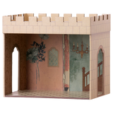 Miniature cardboard dollhouse room with a castle exterior, intricate wallpaper, staircase mural, and chandelier. Arched doorways add an elegant touch.