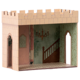 Miniature cardboard dollhouse room with a castle exterior, intricate wallpaper, staircase mural, and chandelier. Arched doorways add an elegant touch.