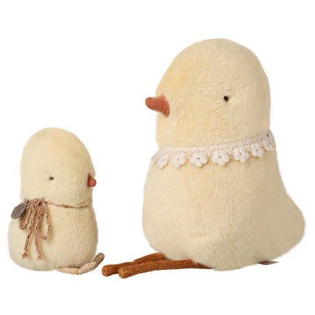 Two plush bird toys on a white background: a small chick with a scarf and a larger bird with a lace collar, both in soft, pale yellow fabric.