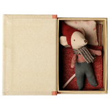 Maileg Christmas mouse toy sleeping in an open book-shaped box with bedding.