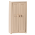 A small, beige, two-door cabinet with simple panel designs and round floral knobs, set against a white background, conveying a minimalist style.