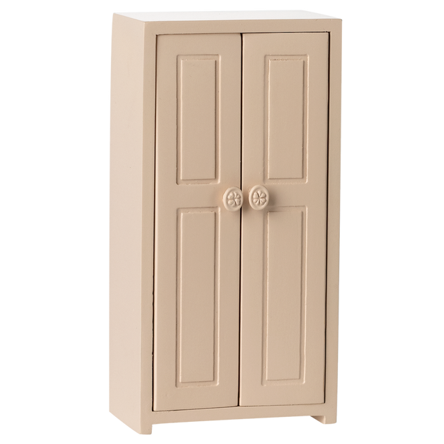 A small, beige, two-door cabinet with simple panel designs and round floral knobs, set against a white background, conveying a minimalist style.
