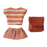 Toy outfit against a white background: striped orange and white top, checkered orange skirt, and a small brown leather-like bag.