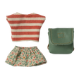 Striped red and white top, floral-patterned green skirt, and a teal leather pouch on a white background. The items appear playful and colorful.