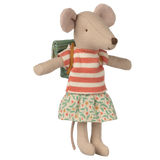 A plush mouse toy wearing a red and white striped top, floral skirt, and a green backpack stands against a white background, exuding a cheerful and whimsical vibe.