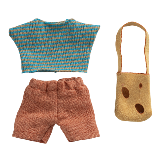 Knitted doll clothes on black background: blue and orange striped top, orange shorts, and yellow bag with brown spots. Casual and playful design.