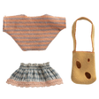 Knitted doll clothes set on black background; includes a peach-striped top, blue patterned skirt with pink trim, and tan shoulder bag with brown spots.