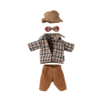 Plaid doll outfit with beige pants, houndstooth hat, and red plaid bow tie. Arranged neatly against a plain background, evoking a vintage charm.
