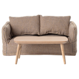 Miniature light wooden coffee table with a smooth, rounded top and tapered legs, adding a minimalist touch to any space.