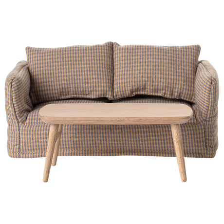 Miniature light wooden coffee table with a smooth, rounded top and tapered legs, adding a minimalist touch to any space.