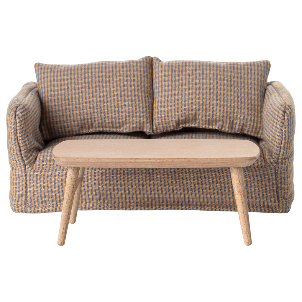 Miniature light wooden coffee table with a smooth, rounded top and tapered legs, adding a minimalist touch to any space.