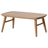 Miniature light wooden coffee table with a smooth, rounded top and tapered legs, adding a minimalist touch to any space.