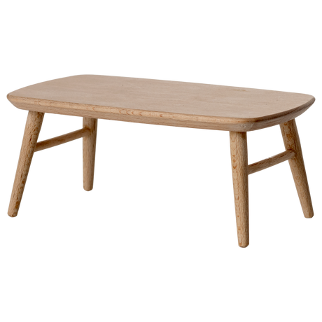 Miniature light wooden coffee table with a smooth, rounded top and tapered legs, adding a minimalist touch to any space.