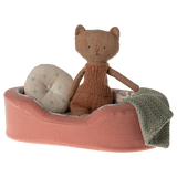 The image shows a soft toy dogs bed in coral, with a pillow and blanket on a white background.