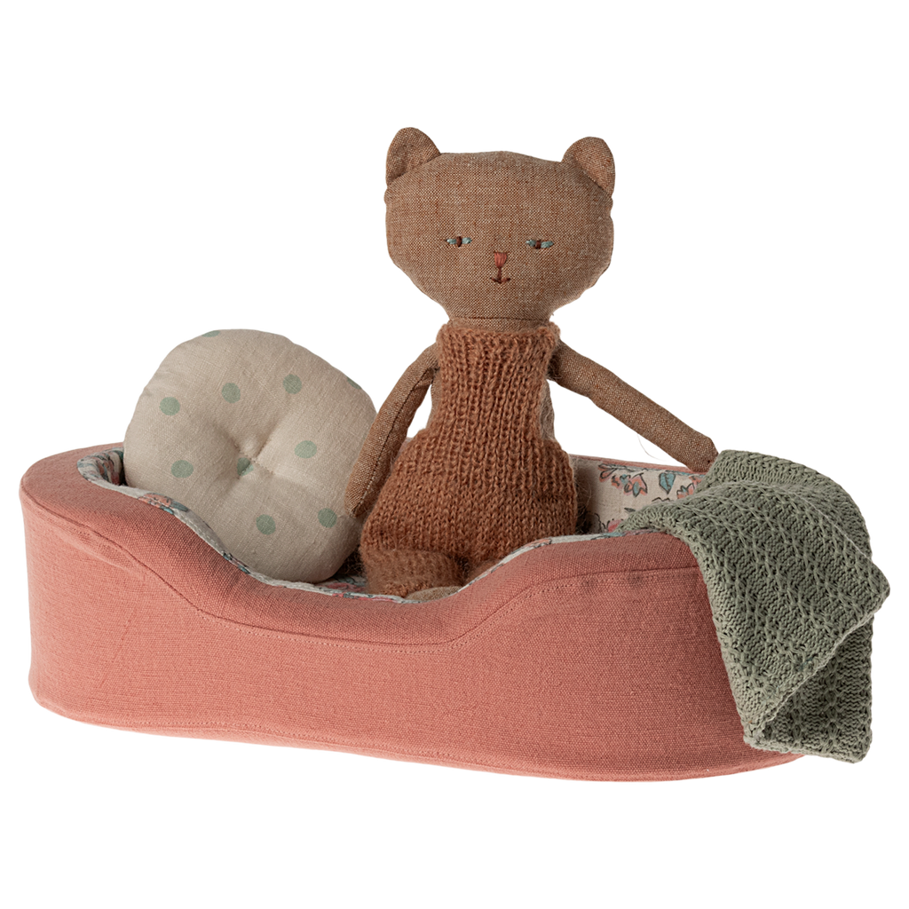 The image shows a soft toy dogs bed in coral, with a pillow and blanket on a white background.