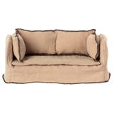 Beige fabric dollhouse sofa with three cushioned backrests, trimmed in dark stitching. The cozy design suggests a miniature living room setting.