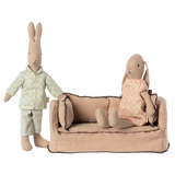 Beige fabric dollhouse sofa with three cushioned backrests, trimmed in dark stitching. The cozy design suggests a miniature living room setting.