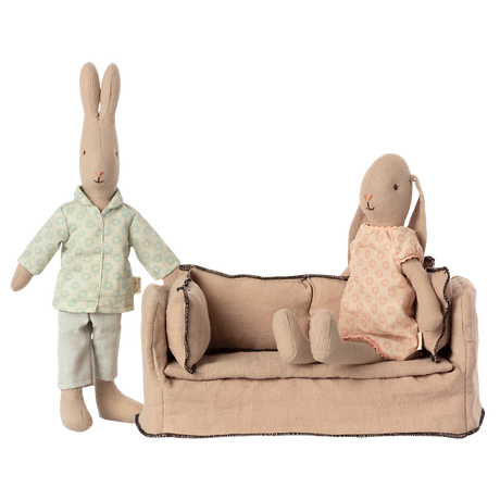 Beige fabric dollhouse sofa with three cushioned backrests, trimmed in dark stitching. The cozy design suggests a miniature living room setting.