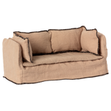 Beige fabric dollhouse sofa with three cushioned backrests, trimmed in dark stitching. The cozy design suggests a miniature living room setting.