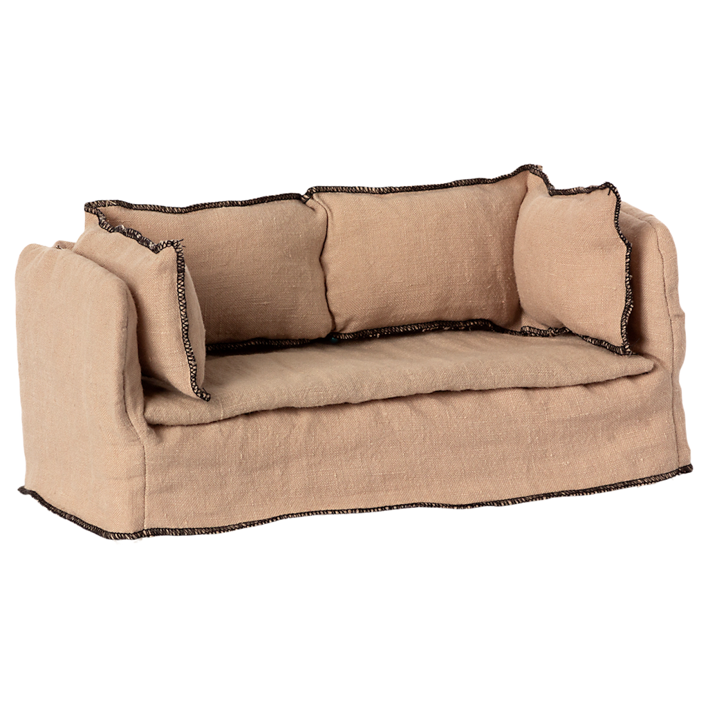 Beige fabric dollhouse sofa with three cushioned backrests, trimmed in dark stitching. The cozy design suggests a miniature living room setting.