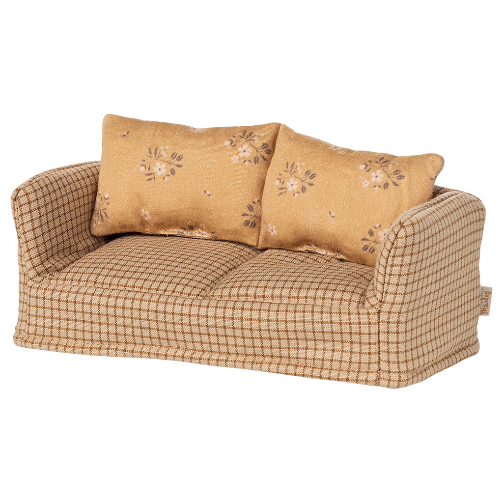 A vintage-style miniature sofa with a beige and brown checkered pattern. It features two floral-patterned cushions, conveying a cozy and nostalgic vibe.