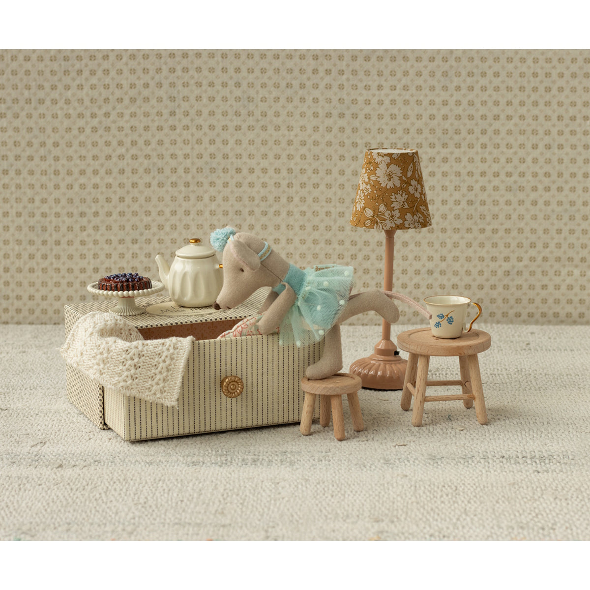 A sweet ballerina mouse in a polka dot outfit, resting on a cozy, vintage-style metal daybed with soft bedding—perfect for imaginative play and dollhouse scenes.