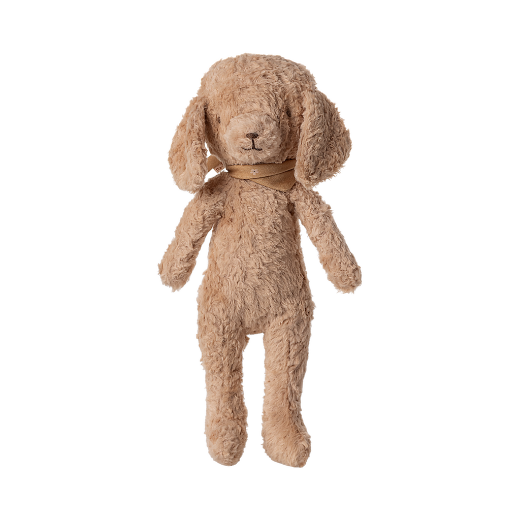 A plush beige dog toy with floppy ears, wearing a brown collar, stands upright against a white background.