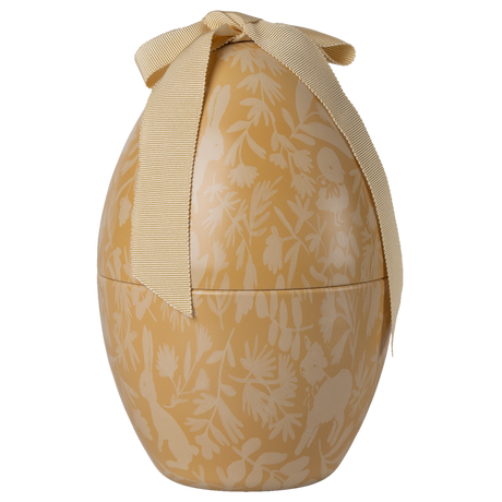 A decorated golden egg-shaped box with a cream floral pattern and animals, topped with a large cream ribbon bow, set against a white background.