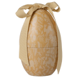 Golden egg-shaped container with white floral and rabbit patterns, tied with an elegant cream ribbon. The image conveys a festive and elegant tone.