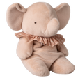 A plush, beige elephant toy with large ears and a curved trunk sits against a white background. It wears a delicate, lace-trimmed pink ruffle.