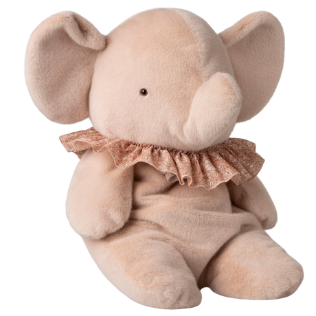 A plush, beige elephant toy with large ears and a curved trunk sits against a white background. It wears a delicate, lace-trimmed pink ruffle.