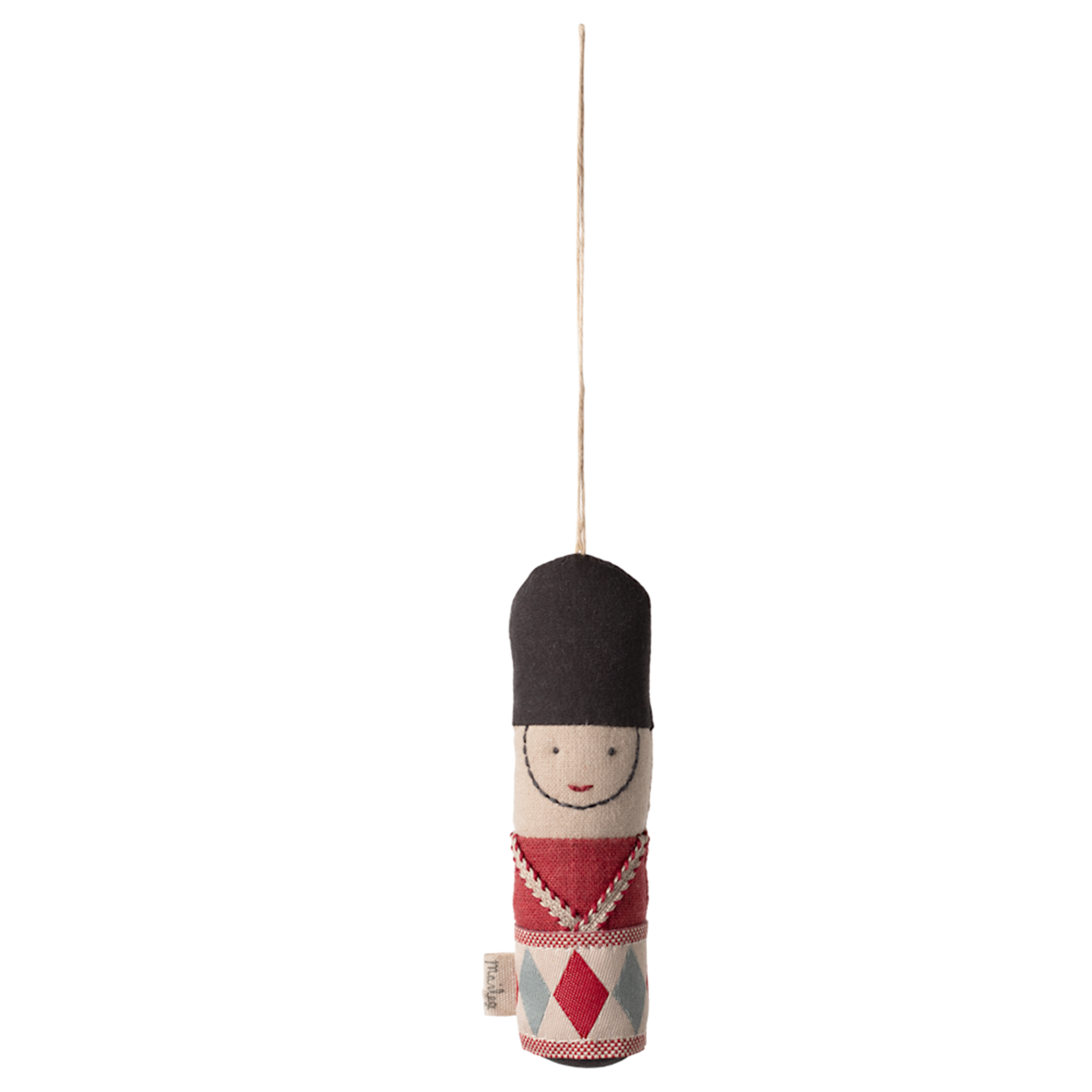A hanging ornament depicting a smiling toy soldier with a tall black hat and red, blue, and white uniform, set against a white background.
