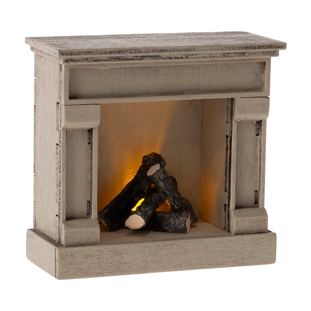 Miniature off-white dollhouse fireplace with a pile of faux logs glowing with a warm orange light.