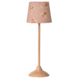 Beige lamp with a floral-patterned shade featuring pink and yellow flowers, set against a white background. The tone is cozy and vintage.