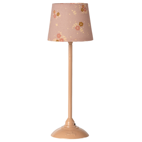 Beige lamp with a floral-patterned shade featuring pink and yellow flowers, set against a white background. The tone is cozy and vintage.