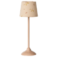 A slender table lamp with a beige floral-patterned shade and matching base, set against a white background. The design evokes a vintage aesthetic.