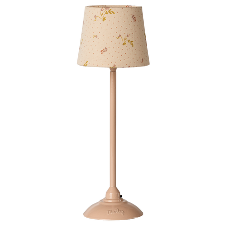 A slender table lamp with a beige floral-patterned shade and matching base, set against a white background. The design evokes a vintage aesthetic.