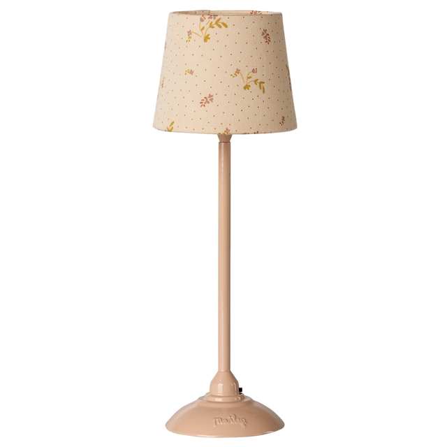 A slender table lamp with a beige floral-patterned shade and matching base, set against a white background. The design evokes a vintage aesthetic.