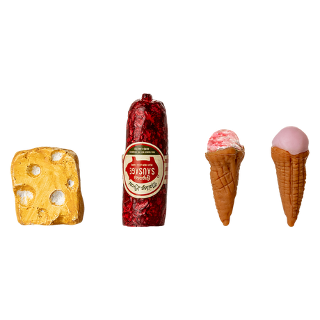 Miniature toy food items displayed against a black background: a yellow cheese wedge, red sausage, and two small ice cream cones, creating a playful tone.