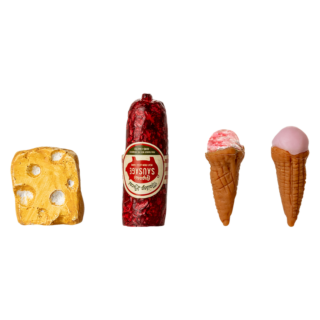 Miniature toy food items displayed against a black background: a yellow cheese wedge, red sausage, and two small ice cream cones, creating a playful tone.