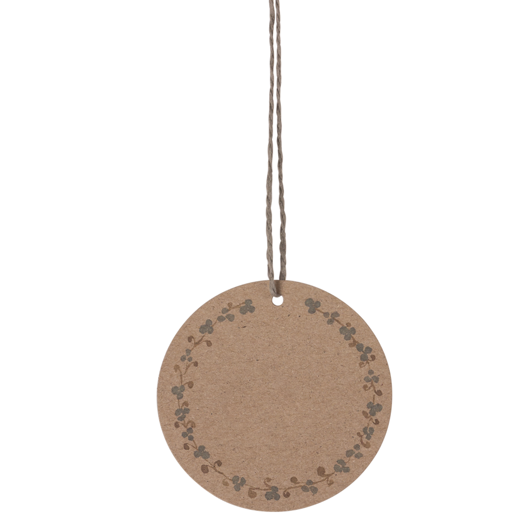 A round, brown paper tag with a floral vine border hangs from a thin string against a white background. The design is simple and rustic.
