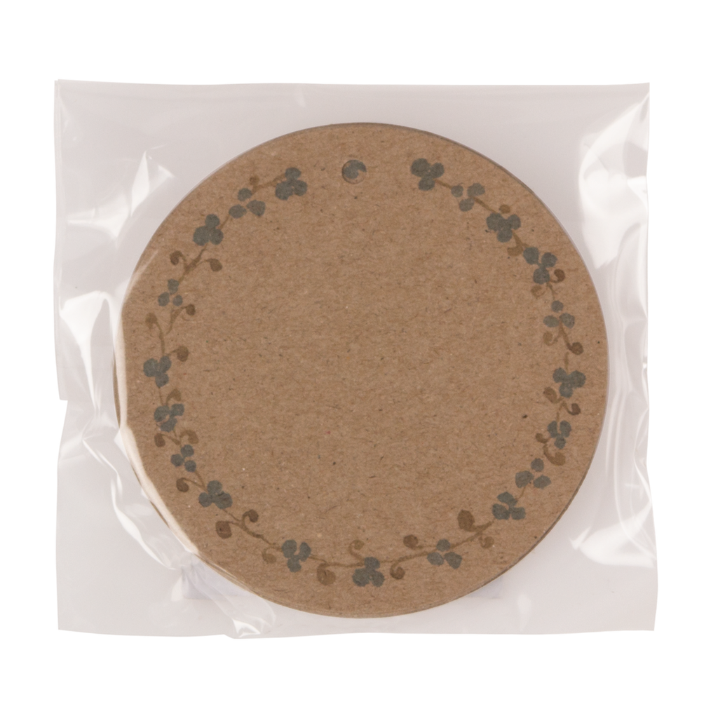 A round, brown paper tag with a floral border design is sealed in clear plastic. The simple, natural material conveys a rustic and minimalist feel.