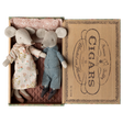 Two fabric mice dolls, one in a floral dress and the other in checkered overalls, lie in a vintage cigar box lined with patterned cloth. Cozy and charming.
