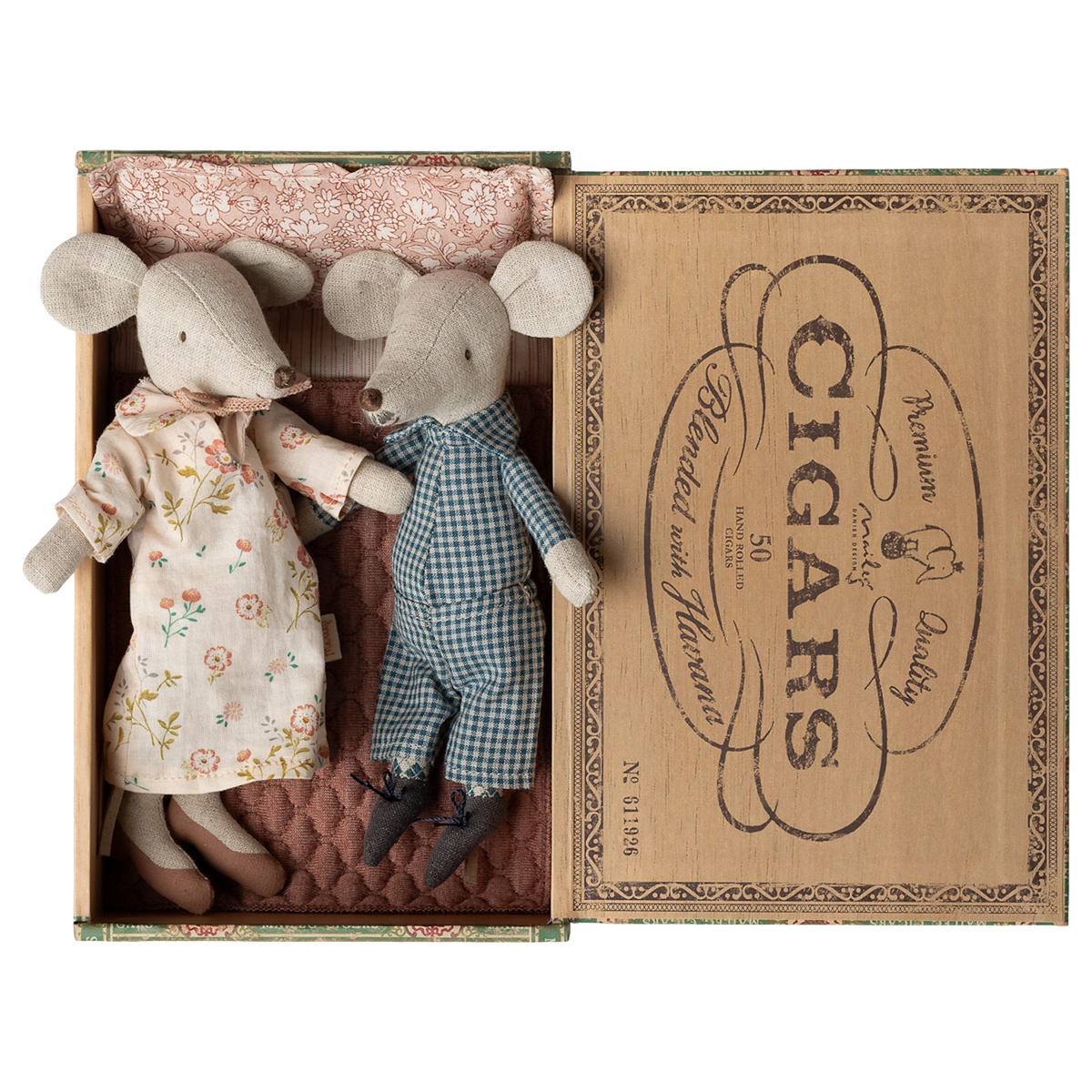 Two fabric mice dolls, one in a floral dress and the other in checkered overalls, lie in a vintage cigar box lined with patterned cloth. Cozy and charming.