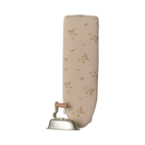 A miniature, foldable ironing board with a floral-patterned surface and a vintage-style iron featuring a wooden handle, set against a plain background.