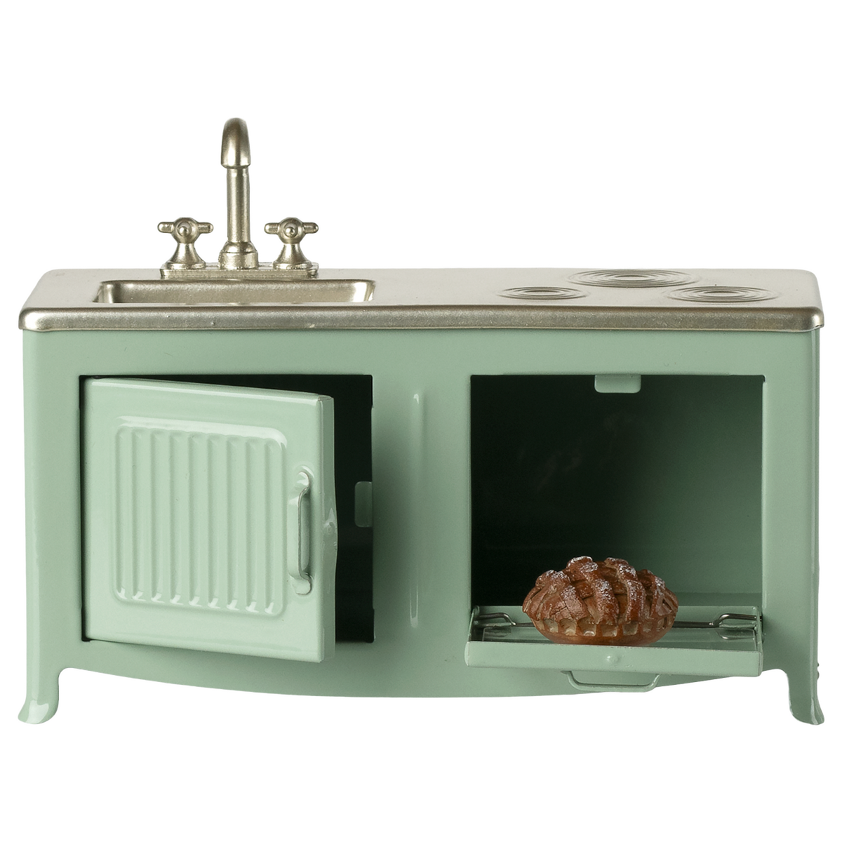 A miniature vintage kitchen set in pale green with a silver faucet and stove. It includes a sink, oven with a glass door, and a visible brown pie inside.