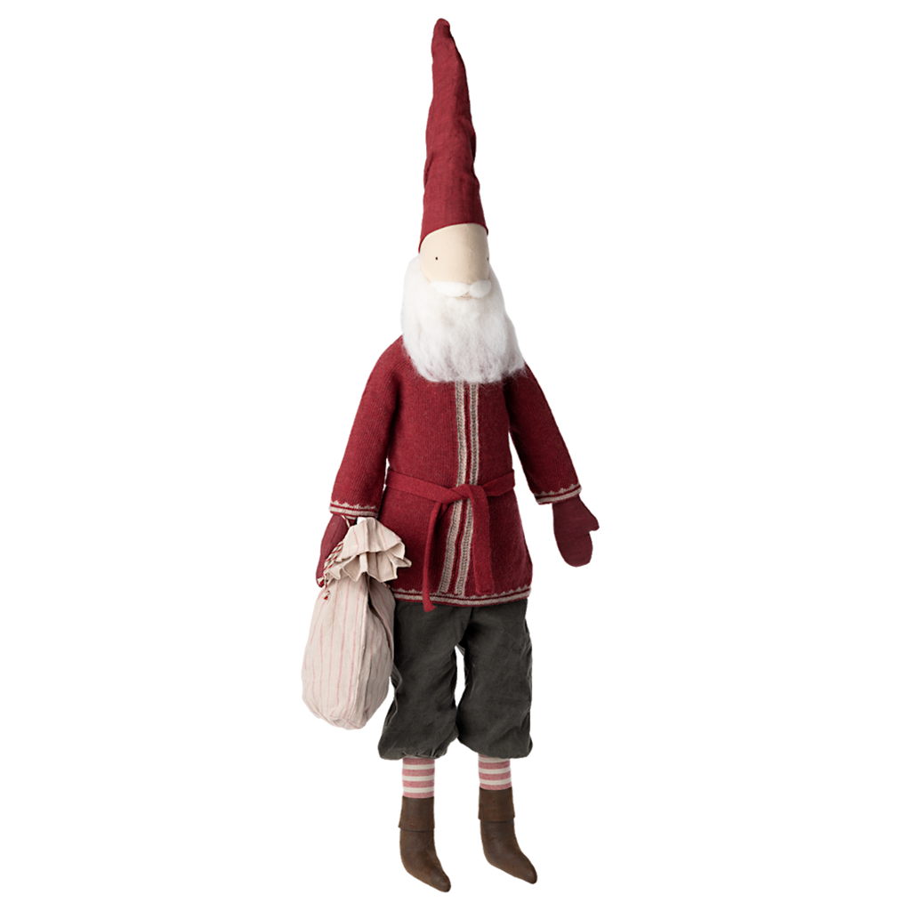 A whimsical Santa doll with a long red hat, red coat, and bushy white beard, holds a sack. Wears striped socks and brown boots, on a white background.