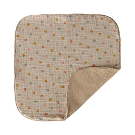 A soft, beige baby blanket with colorful polka dots in orange, green, and yellow. It has rounded corners and a plush backside, creating a cozy feel.