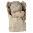 A plush elephant toy with a soft beige body and patterned ears is cozy in a polka-dotted blanket, conveying warmth and comfort against a white background.