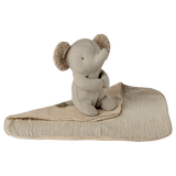 A soft, beige elephant plush toy with patterned ears is sitting on a matching blanket against a white background, conveying a cozy and serene vibe.